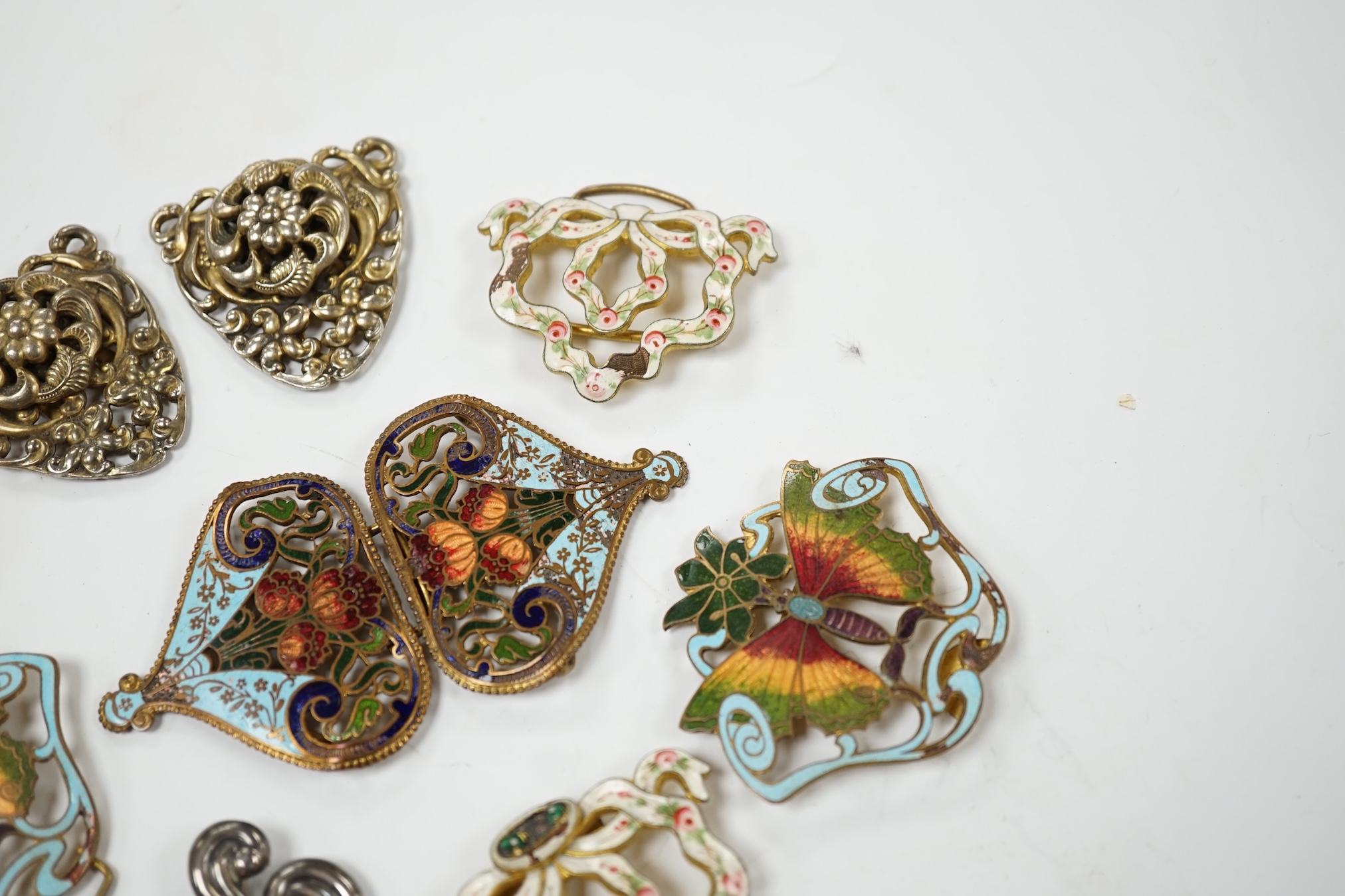 A Mexican Los Castillo sterling and cabochon amethyst set foliate brooch, 60mm, a small collection of base metal and cloisonné enamel belt buckles and a cameo brooch. Condition - poor to fair